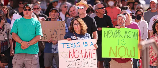 A crowd of people holding signs at a Kindness Rally in Austin, Texas.