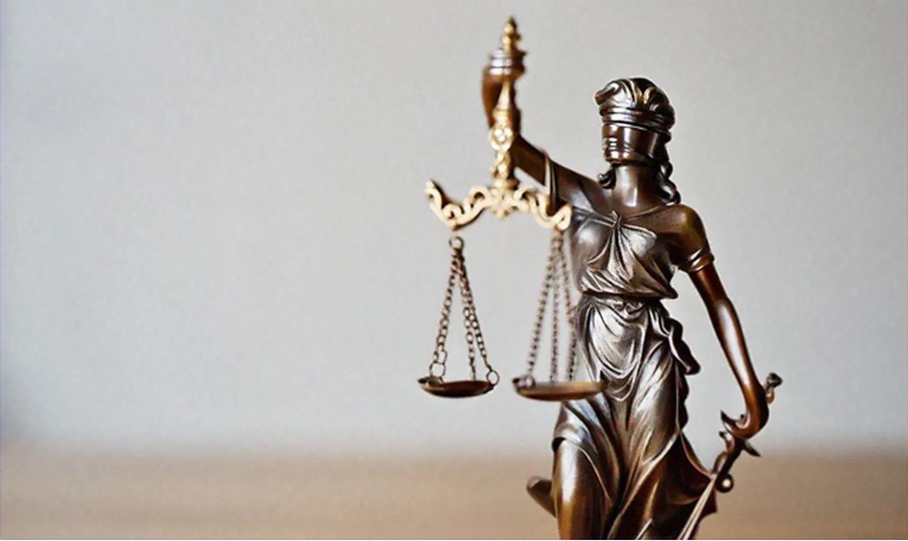 Lady Justice statue representing early legal counsel.